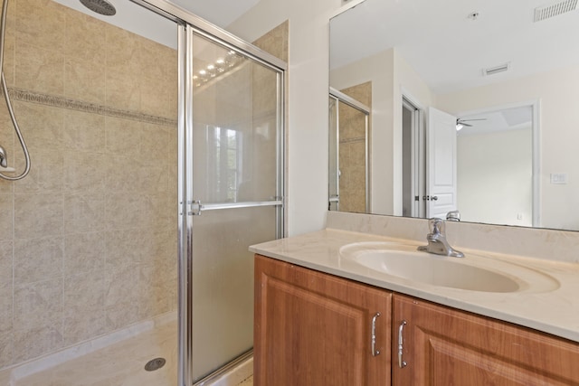 bathroom featuring walk in shower and vanity