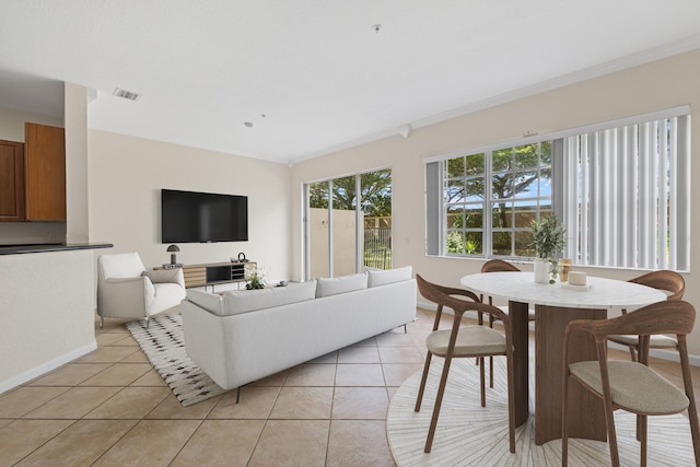 living room with crown molding and light tile patterned floors