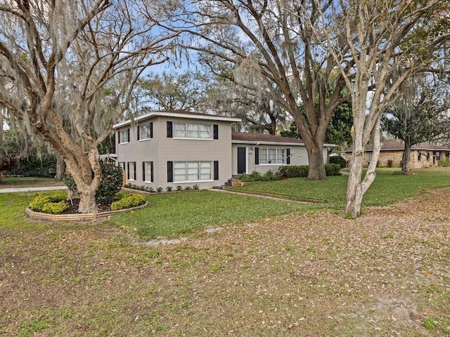 tri-level home with a front yard