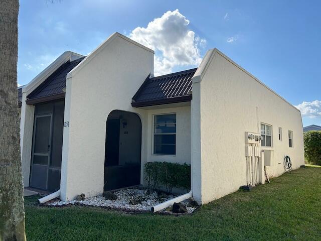 view of home's exterior with a lawn