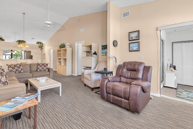 living room featuring ceiling fan with notable chandelier, carpet floors, and high vaulted ceiling