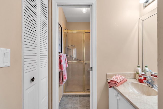 bathroom with vanity, an enclosed shower, and tile patterned floors