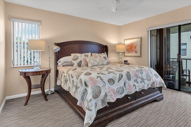 bedroom with multiple windows, a textured ceiling, access to outside, and light carpet