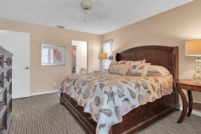 bedroom featuring ceiling fan, dark carpet, and a textured ceiling