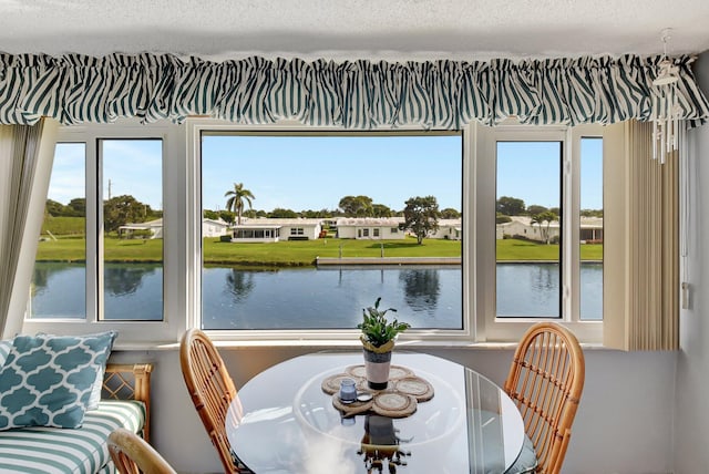 interior space with a textured ceiling and a water view