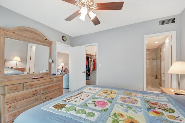 bedroom featuring ceiling fan, a walk in closet, and ensuite bathroom