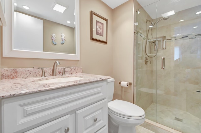 bathroom with vanity, an enclosed shower, and toilet