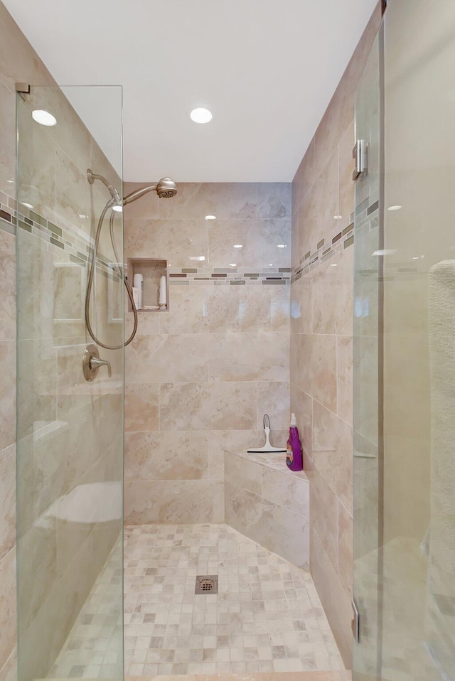 bathroom featuring a shower with shower door