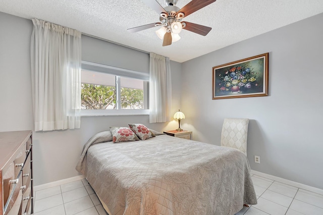 tiled bedroom with ceiling fan and a textured ceiling