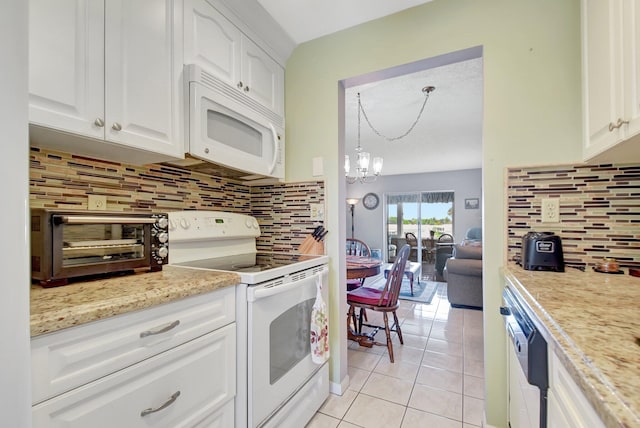 kitchen with white appliances, white cabinetry, light tile patterned flooring, decorative backsplash, and a chandelier