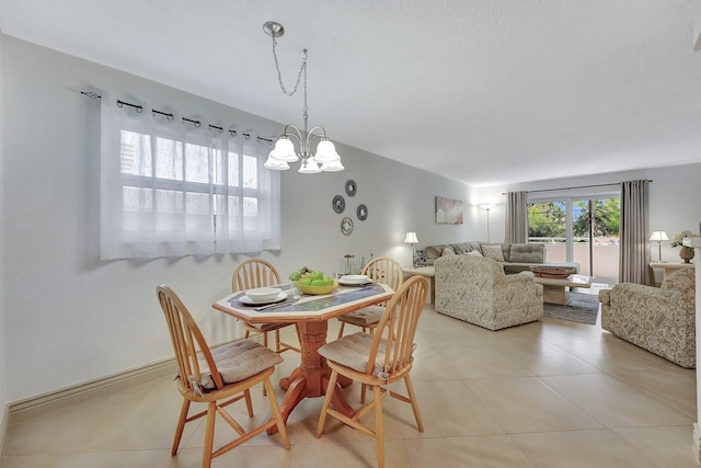 dining area with light tile patterned flooring and a chandelier