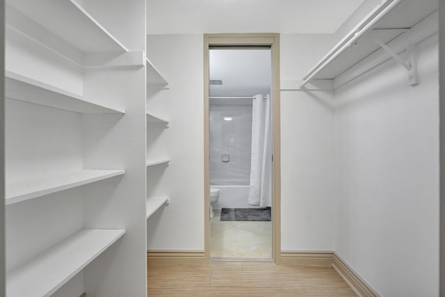 walk in closet featuring wood-type flooring