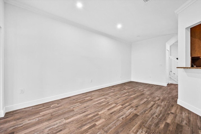 unfurnished living room featuring ornamental molding and dark hardwood / wood-style floors