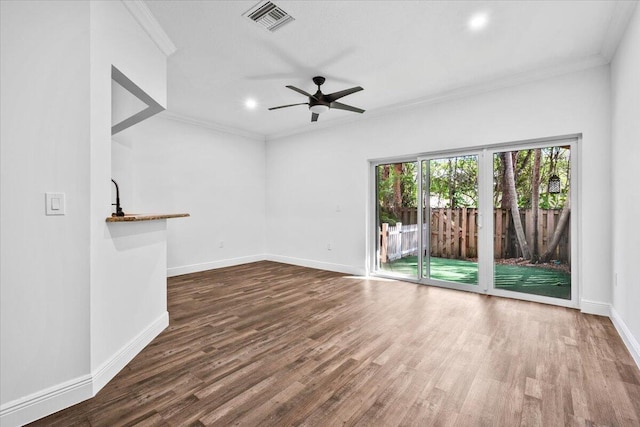 unfurnished living room featuring ornamental molding, wood-type flooring, and ceiling fan