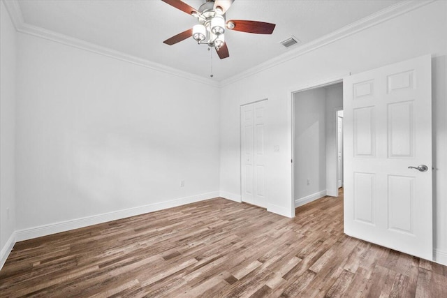 spare room with crown molding, ceiling fan, and light hardwood / wood-style floors