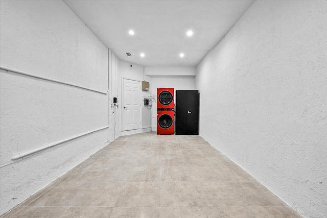 garage with stacked washer and dryer