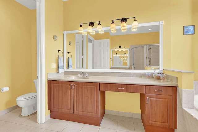 bathroom with tile patterned floors, toilet, a shower with door, and vanity