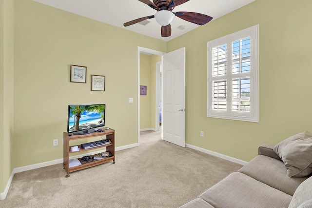 living area with light colored carpet and ceiling fan