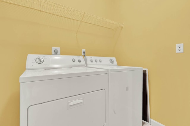 laundry area with washing machine and clothes dryer