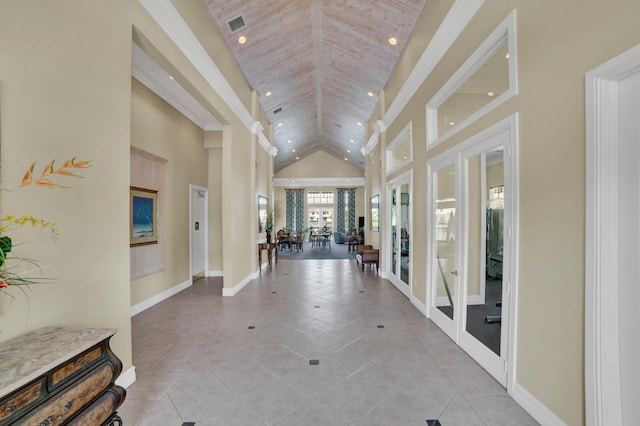 hallway featuring french doors, high vaulted ceiling, and light tile patterned floors