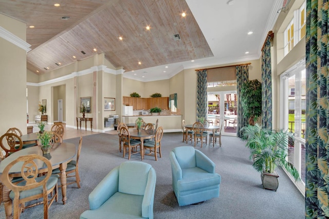 dining area featuring wood ceiling, crown molding, and a high ceiling