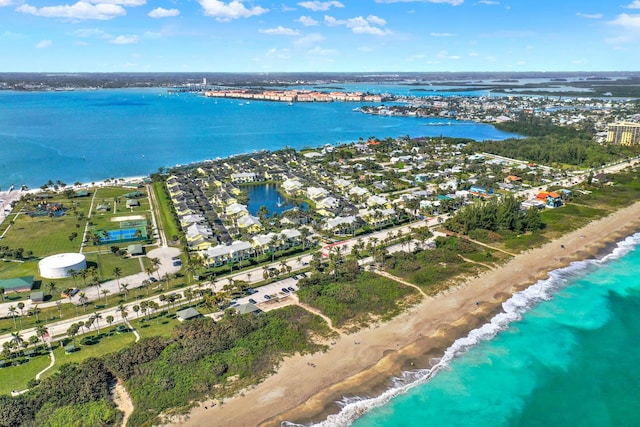 birds eye view of property with a water view and a view of the beach