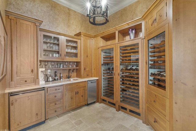 wine room featuring ornamental molding, a chandelier, and indoor wet bar