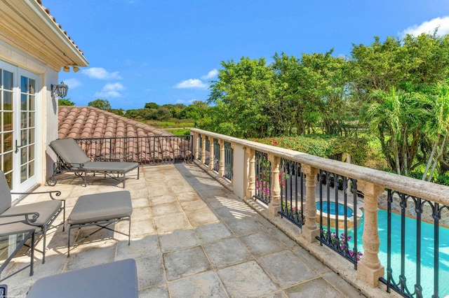 view of patio / terrace featuring a balcony and french doors