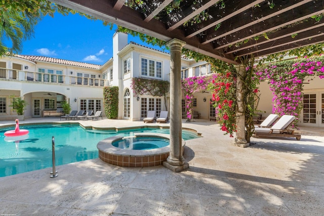 view of pool with french doors, an in ground hot tub, and a patio area