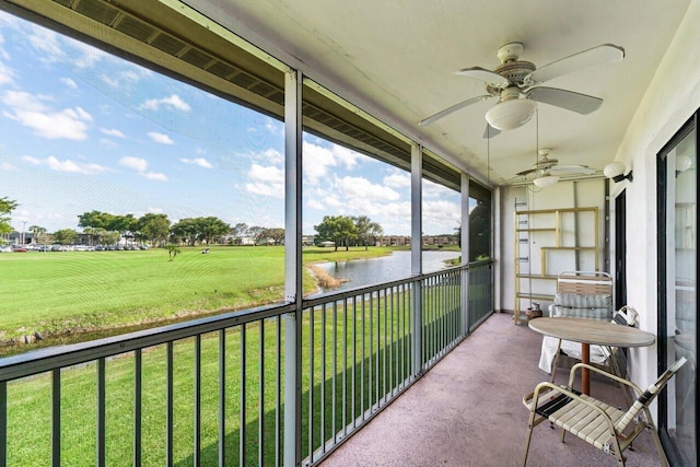 unfurnished sunroom featuring a water view and a ceiling fan