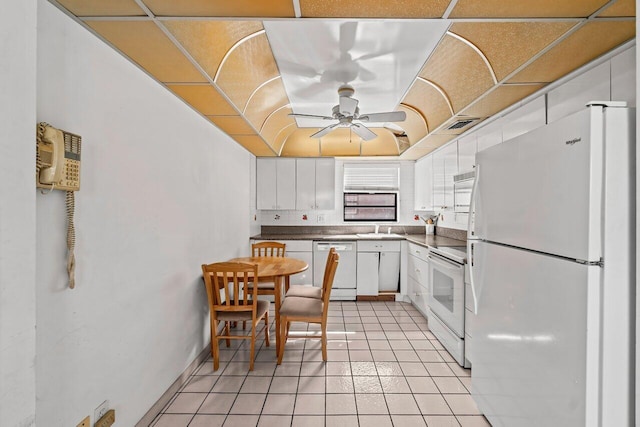 kitchen with white appliances, ceiling fan, white cabinetry, a sink, and light tile patterned flooring