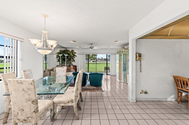 dining area with a textured ceiling, ceiling fan, and light tile patterned flooring