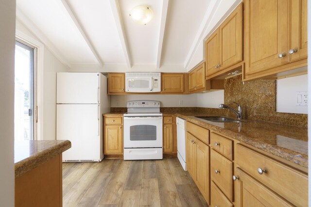 kitchen with tasteful backsplash, sink, vaulted ceiling with beams, white appliances, and light hardwood / wood-style flooring