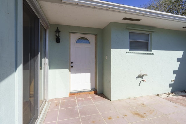 doorway to property with a patio