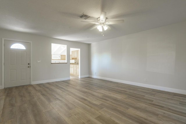 foyer entrance with wood-type flooring and ceiling fan