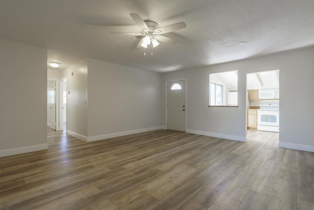 interior space with dark wood-type flooring and ceiling fan