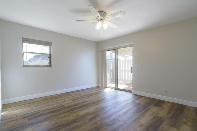 empty room with dark wood-type flooring, baseboards, and a ceiling fan