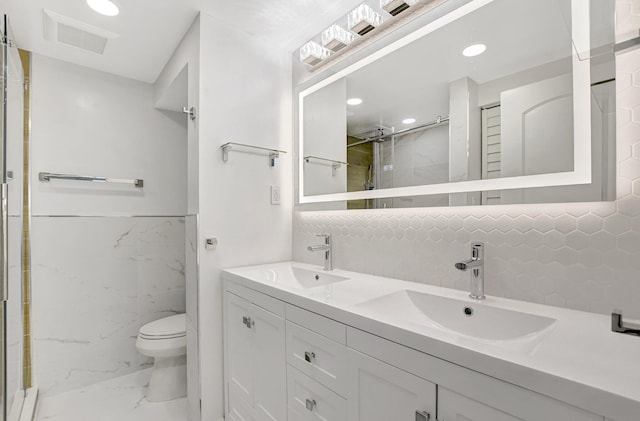 bathroom featuring toilet, vanity, and walk in shower