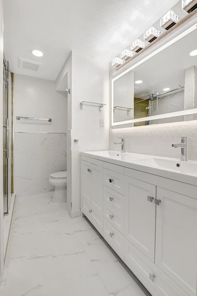 full bathroom with visible vents, marble finish floor, a shower stall, and double vanity