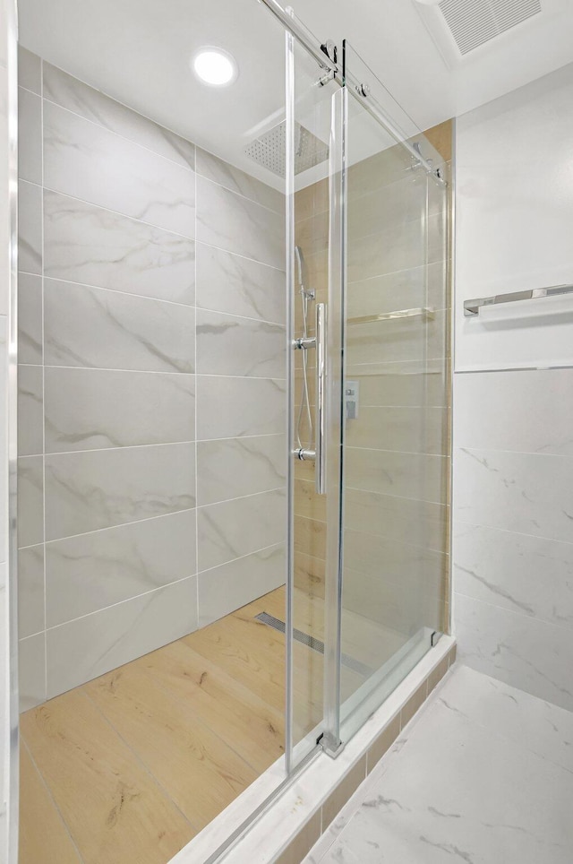 bathroom with recessed lighting, visible vents, and a shower stall