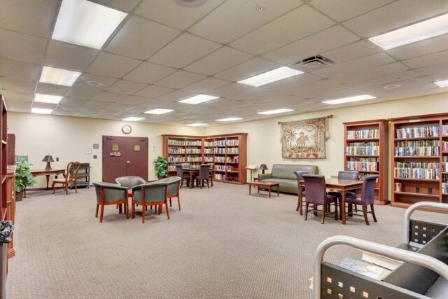 dining space with plenty of natural light and a paneled ceiling