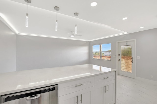 kitchen with hanging light fixtures, stainless steel dishwasher, and white cabinets