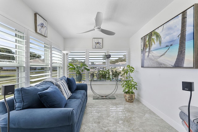 sunroom with ceiling fan