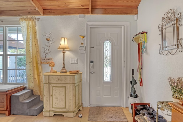 entryway featuring light tile patterned flooring and wood ceiling