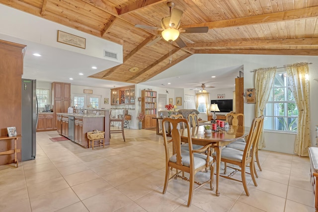 tiled dining area with ceiling fan, vaulted ceiling with beams, and wood ceiling