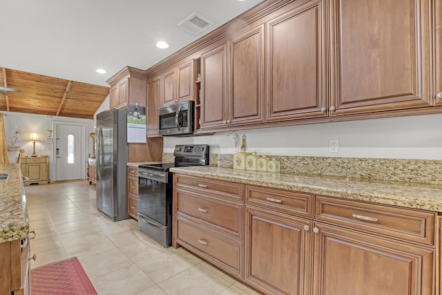 kitchen with vaulted ceiling, appliances with stainless steel finishes, light tile patterned flooring, wood ceiling, and light stone countertops