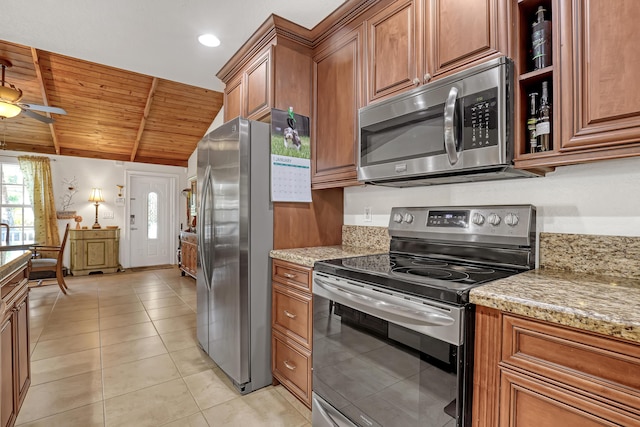 kitchen featuring light tile patterned flooring, wood ceiling, vaulted ceiling, appliances with stainless steel finishes, and light stone countertops