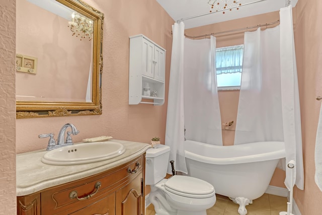 bathroom with vanity, toilet, and a tub