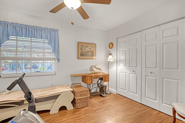 sitting room with ceiling fan and light wood-type flooring