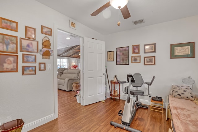 exercise area with ceiling fan and light hardwood / wood-style flooring